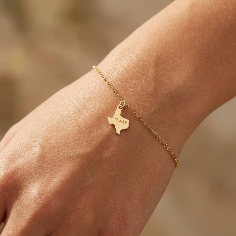 Fine chain bracelet with a small flat Texas state outline charm in gold (2 of 6)