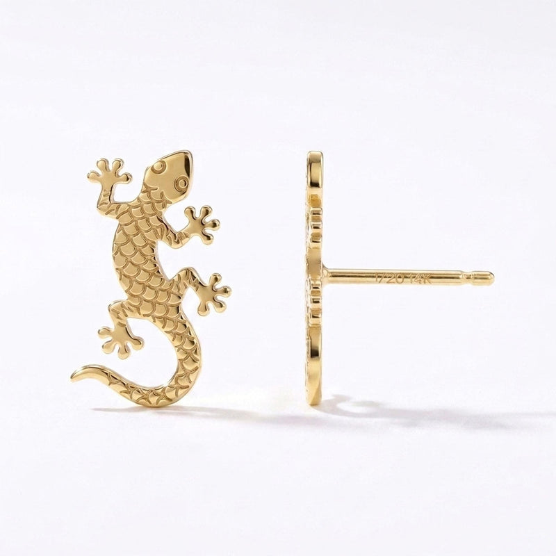 Pair of gold gecko stud earrings with splayed toes and curled tails