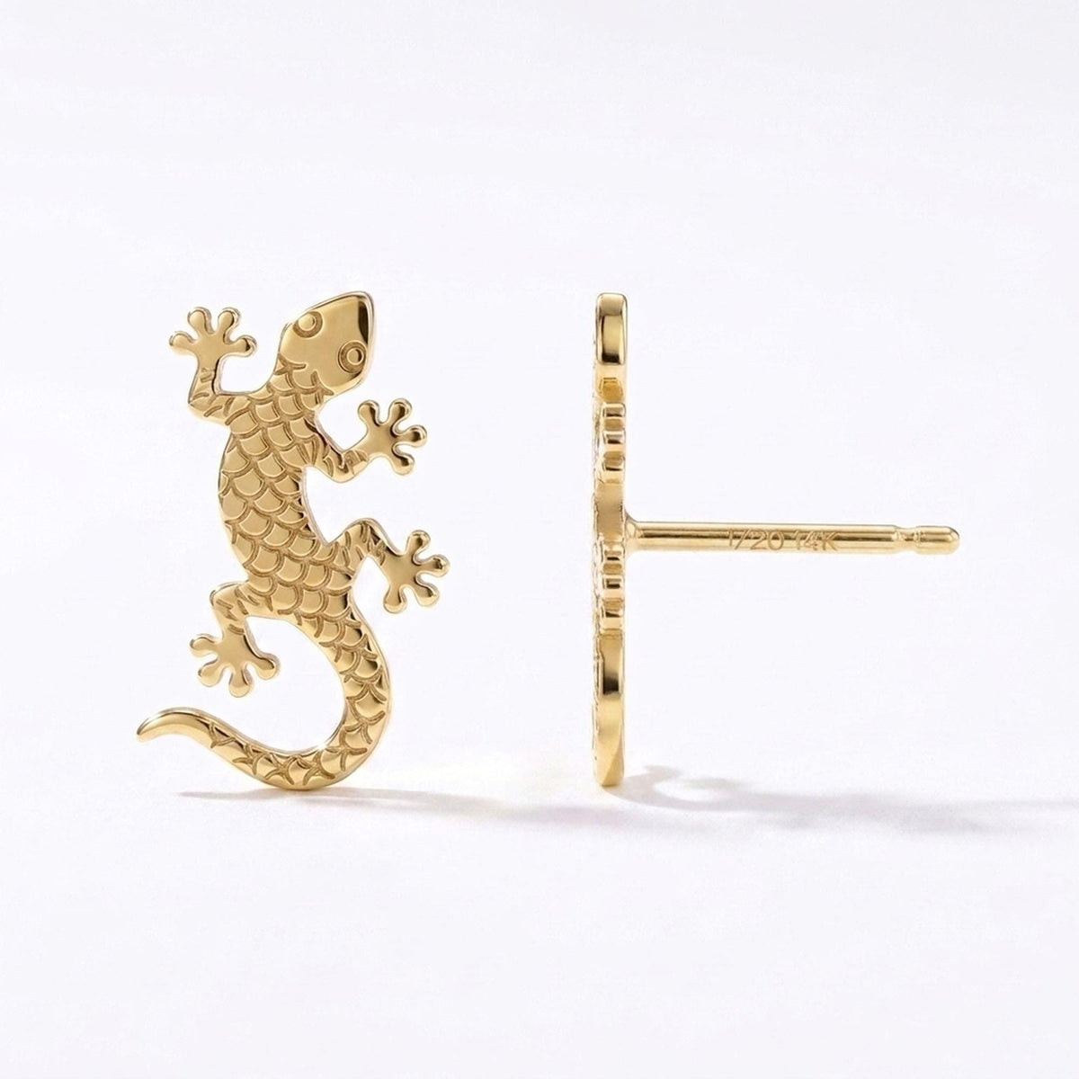 Pair of gold gecko stud earrings with splayed toes and curled tails
