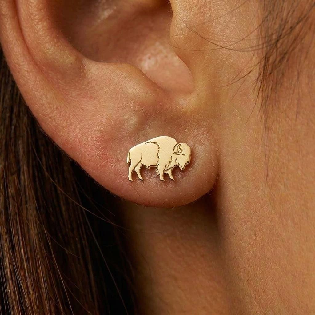 Small gold bison stud earrings shown in side profile with low head (2 of 8)
