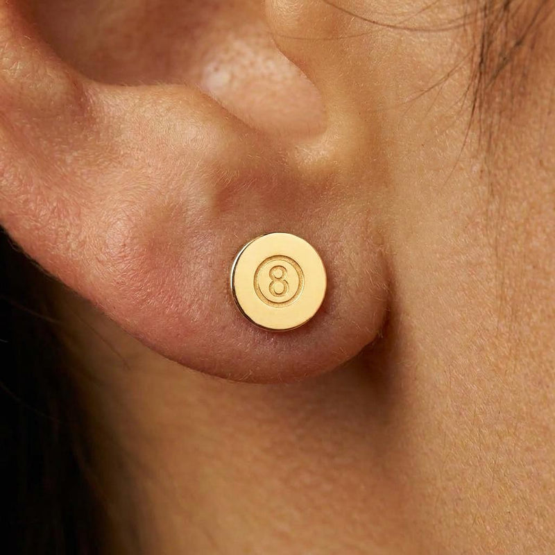 Pair of tiny gold eight ball stud earrings with the number cut into a raised circle (2 of 8)