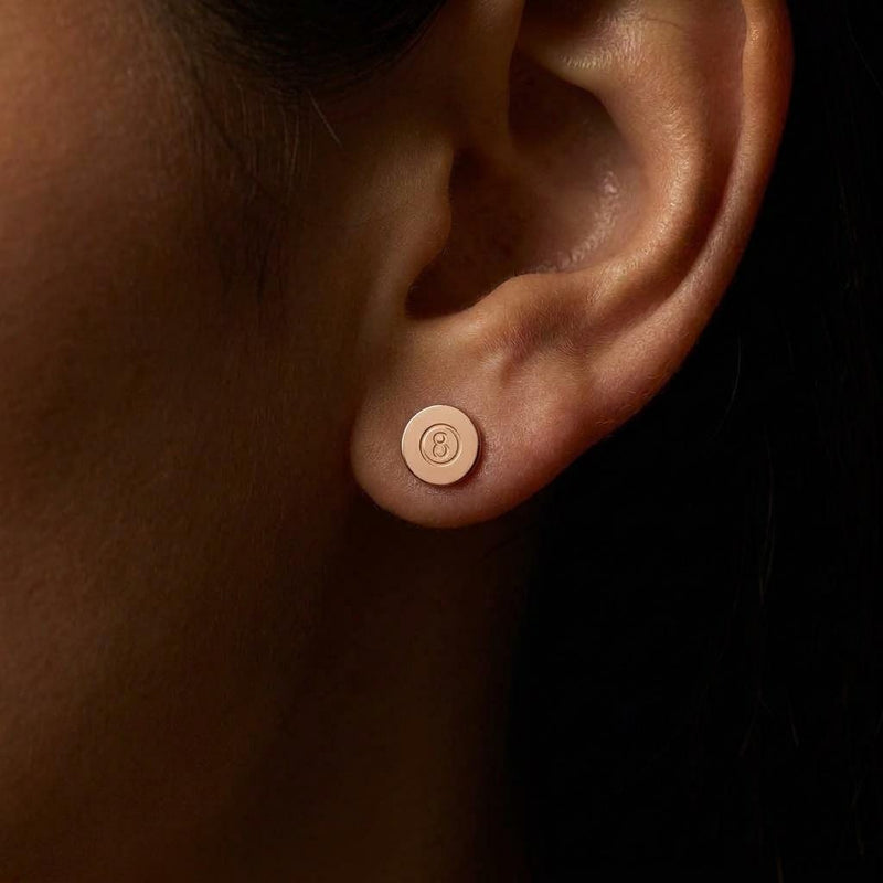 Pair of tiny gold eight ball stud earrings with the number cut into a raised circle (5 of 8)