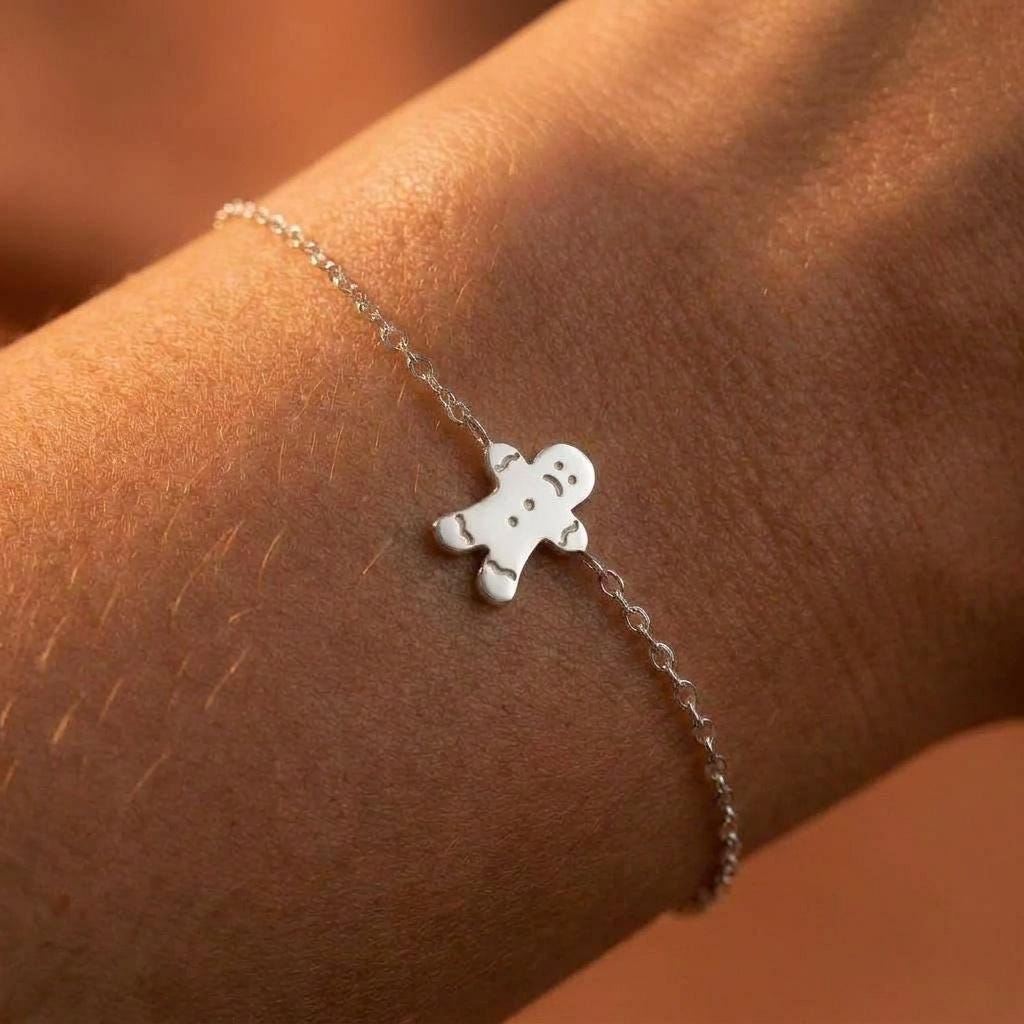 Tiny gingerbread man charm with a frowning face on a fine gold chain bracelet (2 of 6)