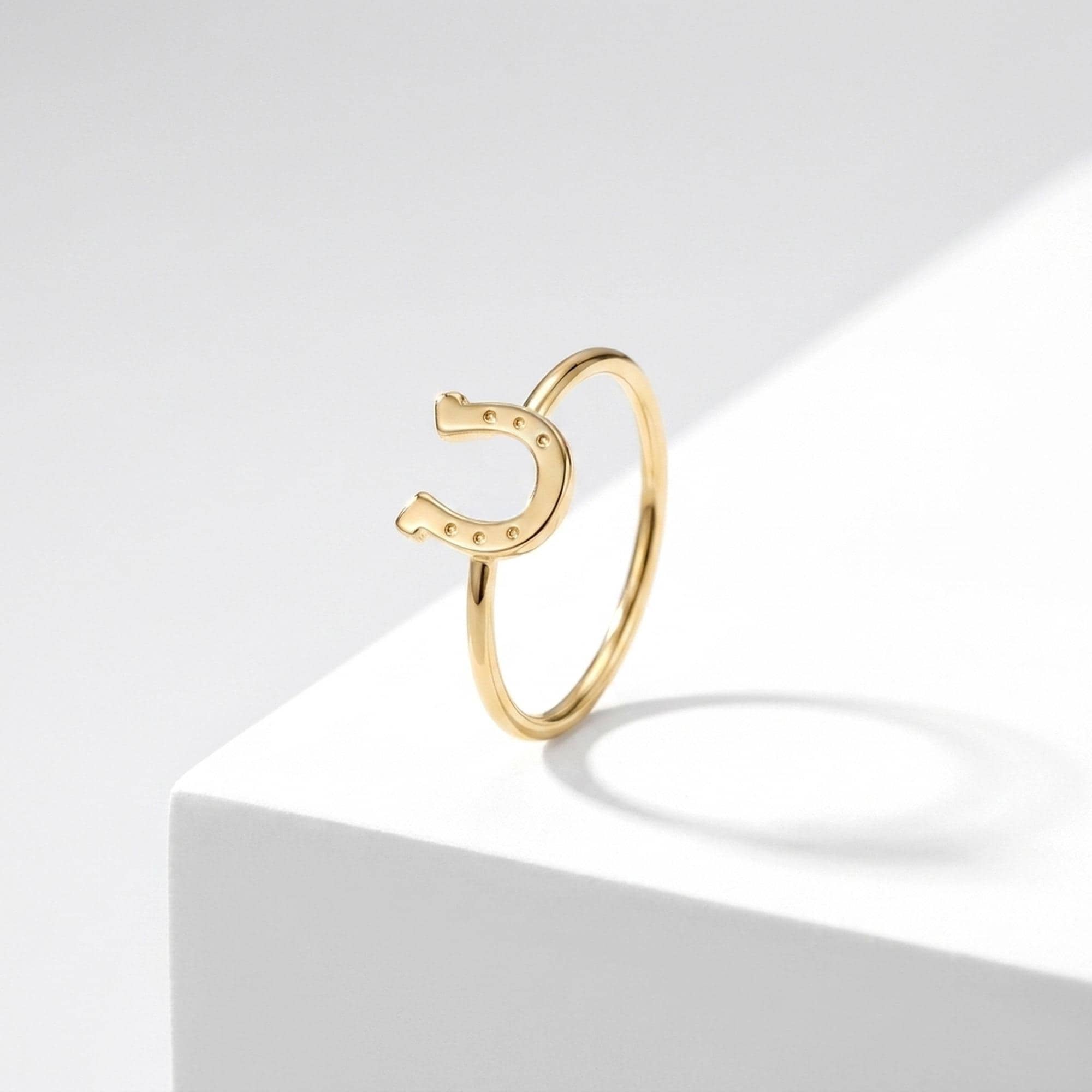 Dainty gold horseshoe ring with a thin band and a small sculpted horseshoe across the top (2 of 8)