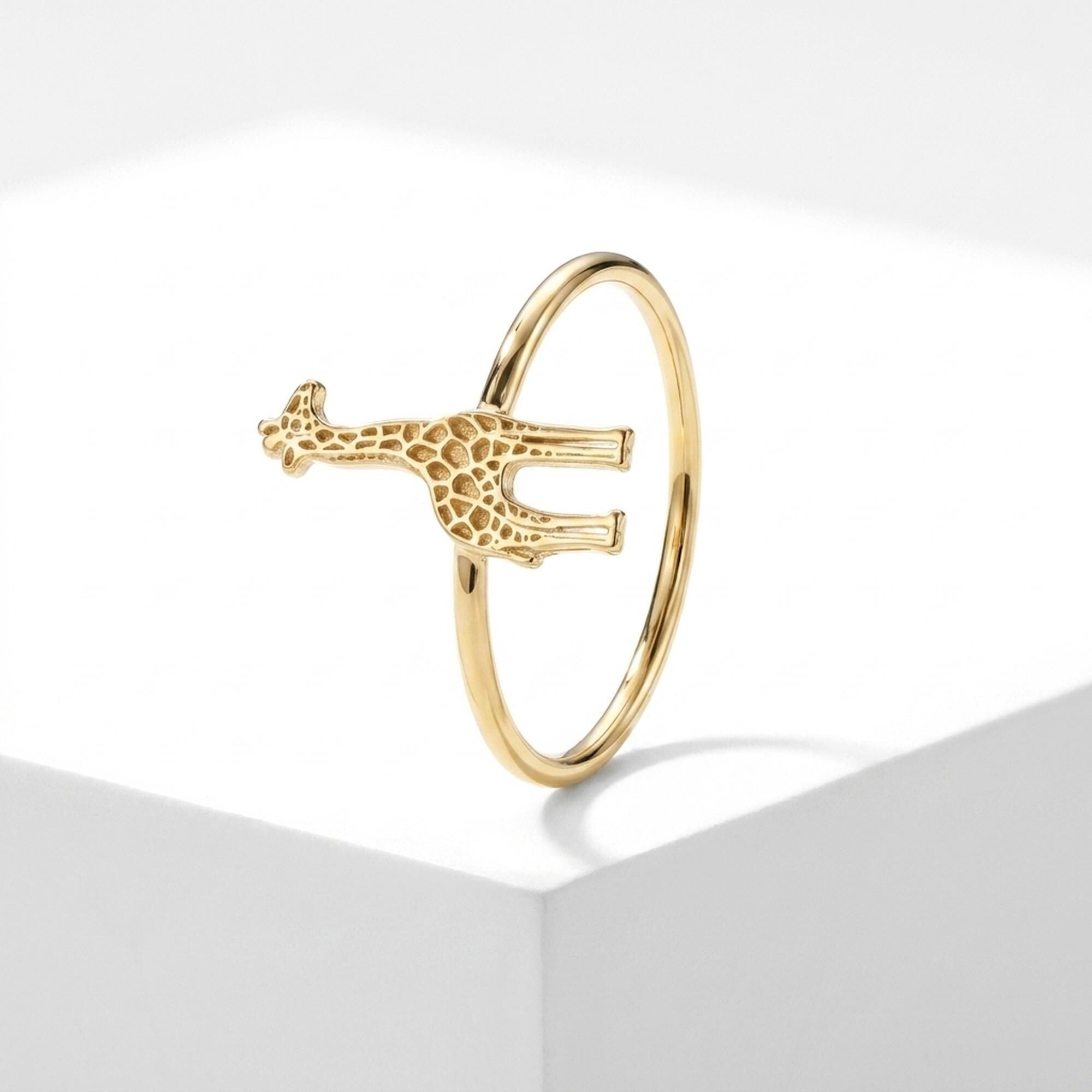 Thin gold ring with a small sculpted giraffe across the top, spots cut into the body (2 of 7)
