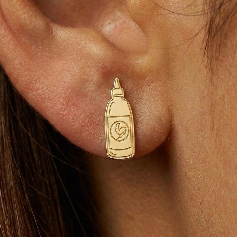Pair of gold earrings shaped like a tapered hot sauce squeeze bottle with a pointed cap (2 of 8)