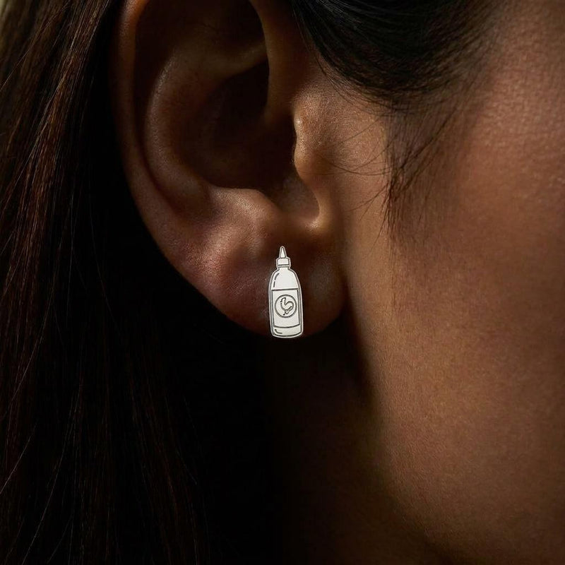 Pair of gold earrings shaped like a tapered hot sauce squeeze bottle with a pointed cap (3 of 8)