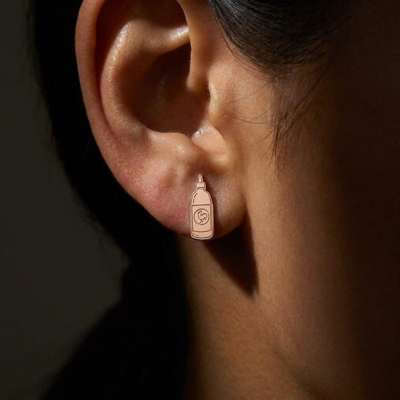 Pair of gold earrings shaped like a tapered hot sauce squeeze bottle with a pointed cap (4 of 8)