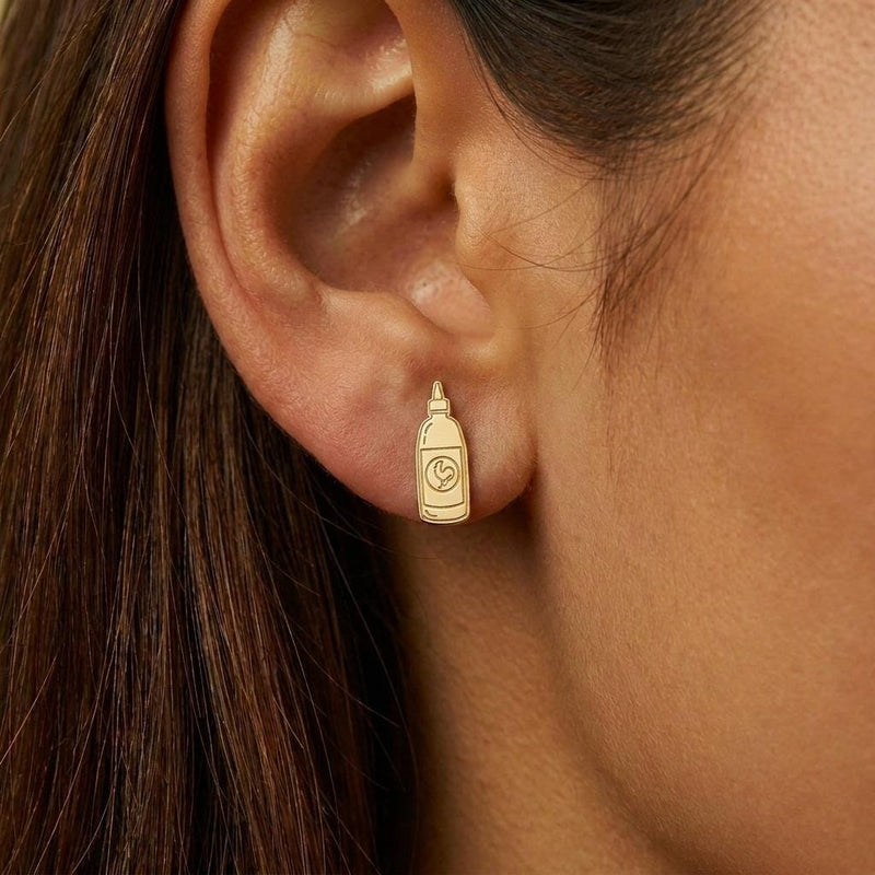 Pair of gold earrings shaped like a tapered hot sauce squeeze bottle with a pointed cap (5 of 8)