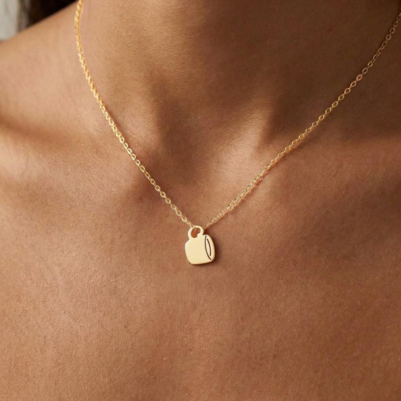 Fine gold chain necklace with a small coffee cup pendant with lid and sleeve