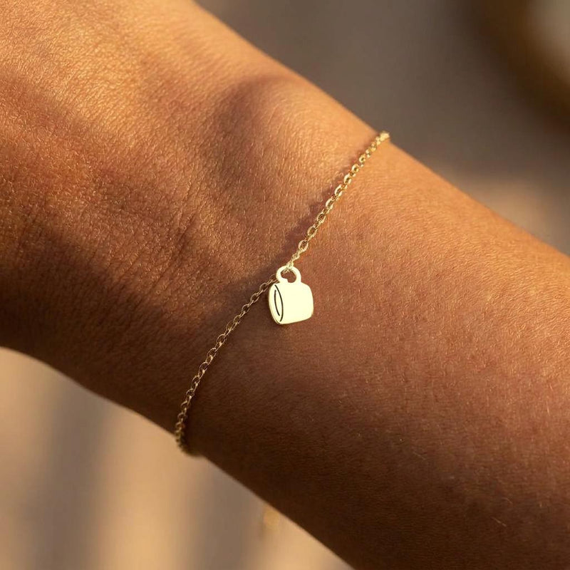 Fine gold chain bracelet with a small coffee cup charm and lobster clasp. (2 of 6)