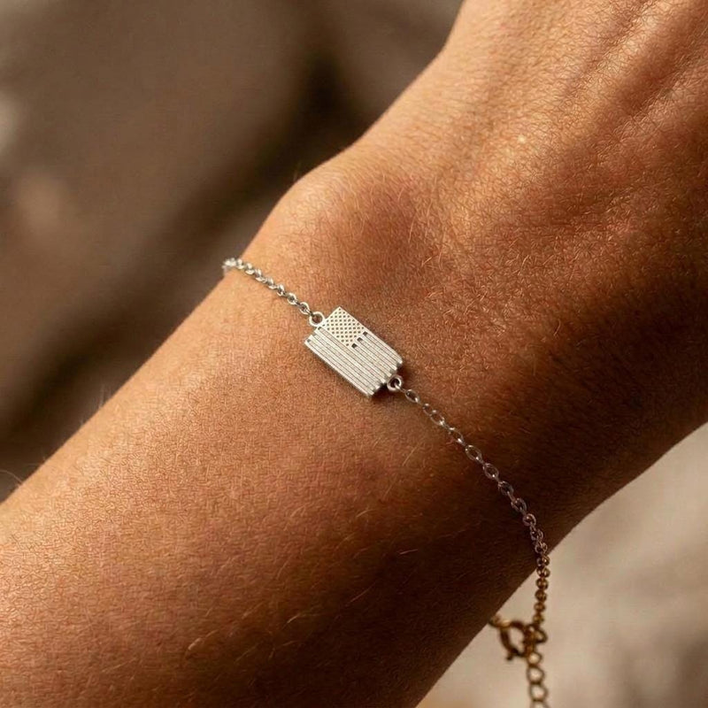 Tiny gold American flag charm with cut stripes and a star field on a fine chain bracelet (2 of 6)