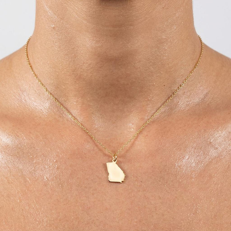 Dainty gold state outline pendant on a fine cable chain, shown flat on white (3 of 8)