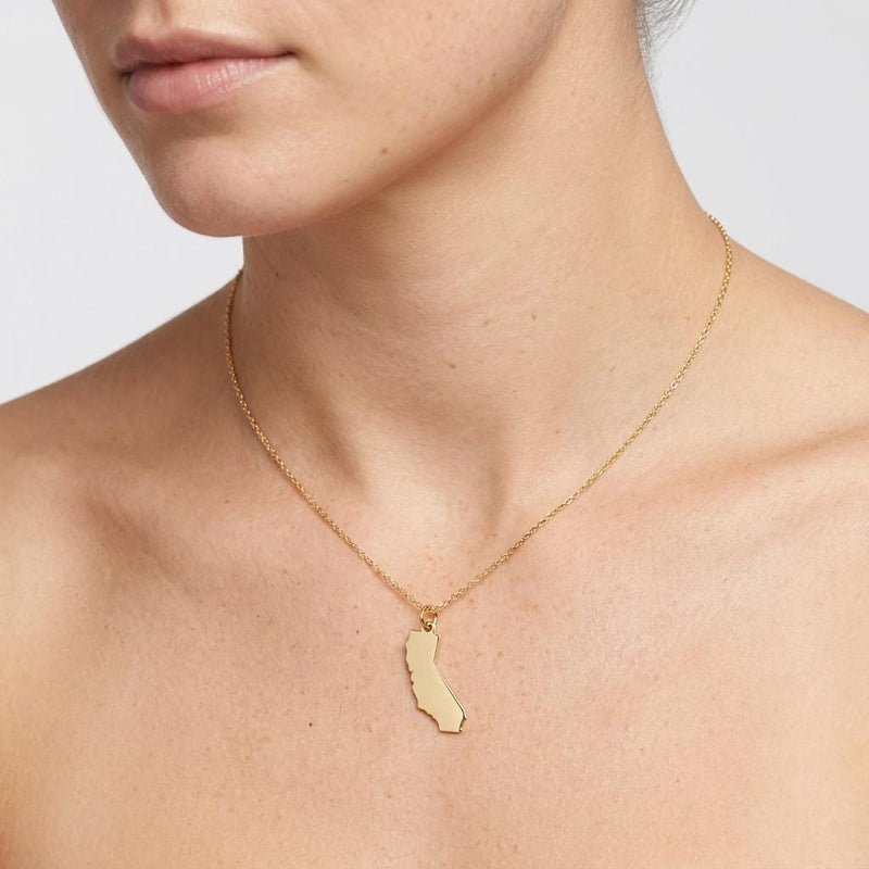 Dainty gold state outline pendant on a fine cable chain, shown flat on white (6 of 8)
