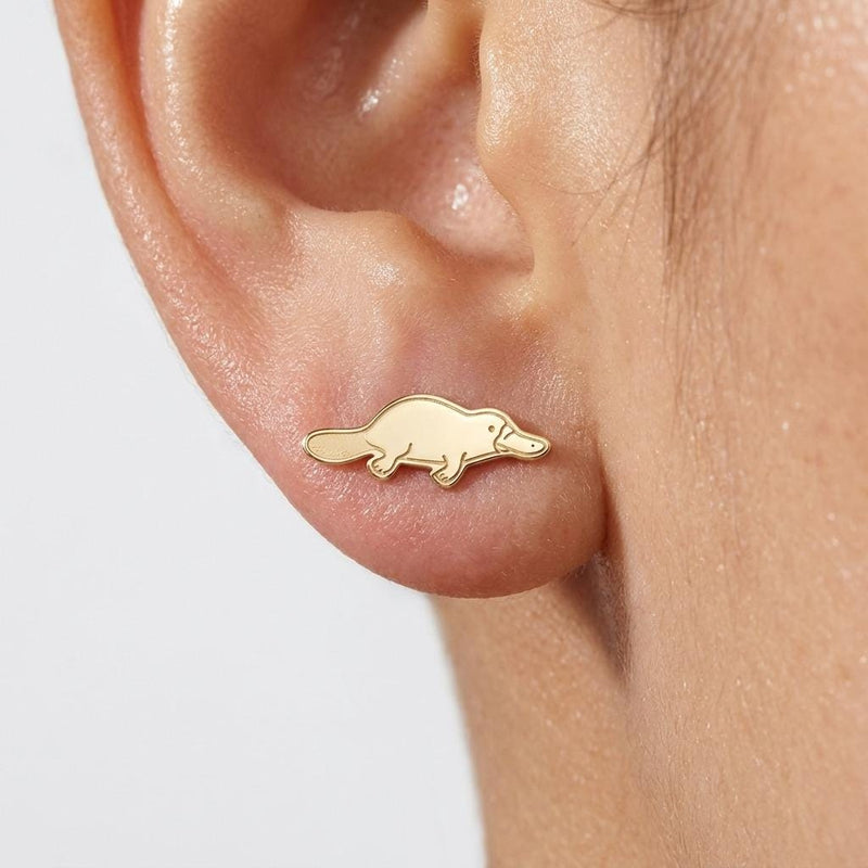 Pair of small gold platypus stud earrings with bill and flat tail, on a white background (2 of 5)