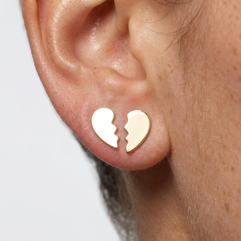 Pair of tiny gold broken heart stud earrings, each a half heart with a jagged edge (2 of 6)