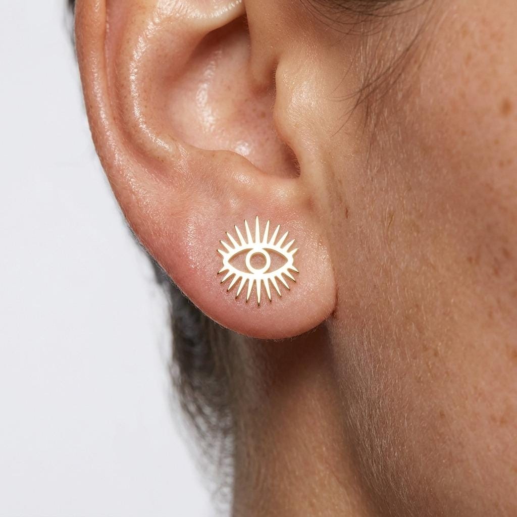 Pair of small gold evil eye stud earrings with an almond-shaped eye motif (2 of 6)