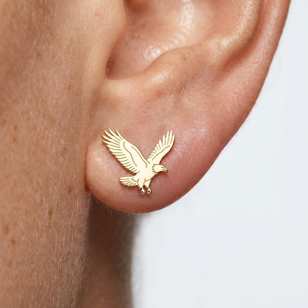 Pair of gold bald eagle stud earrings with spread wings