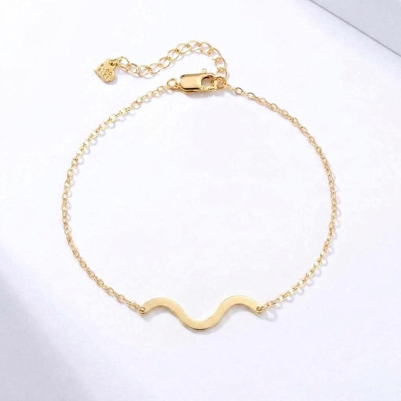Gold bracelet with a winding river charm on a fine wave link chain (2 of 6)