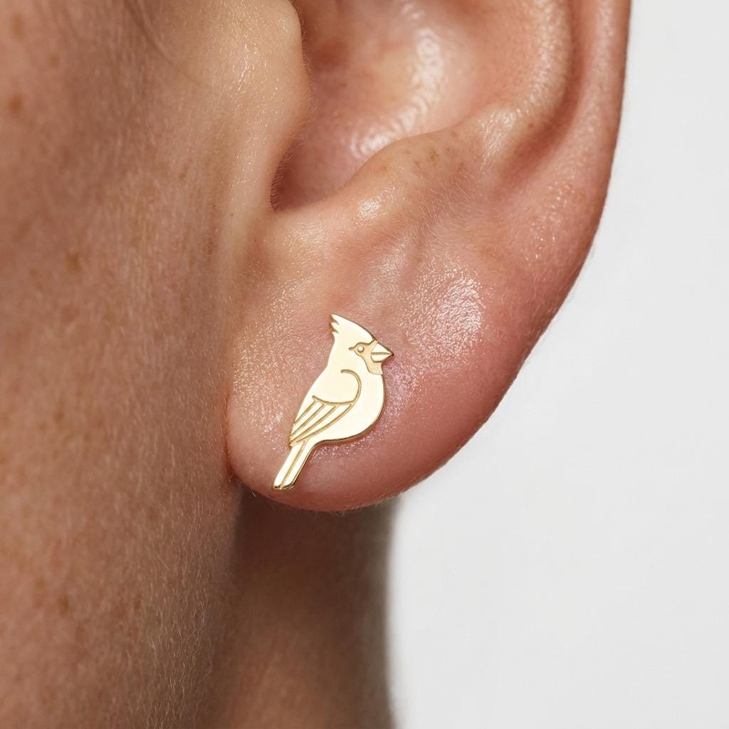 Pair of small gold cardinal bird stud earrings shown on a white background (2 of 7)