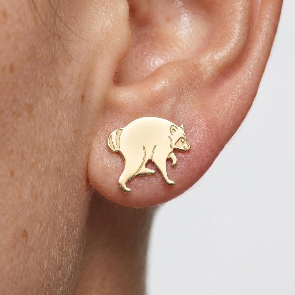 Tiny gold raccoon stud earrings shown standing with front paws raised (2 of 6)