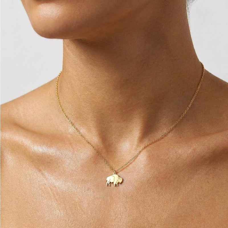 Fine gold chain necklace with a small bison charm shown in profile