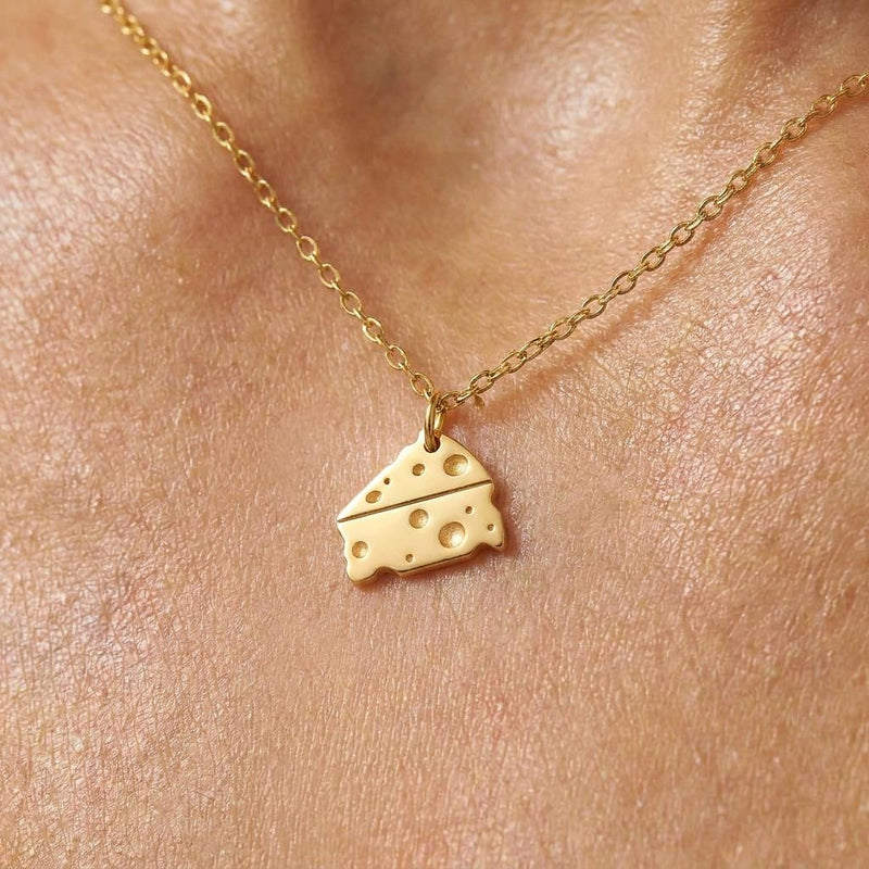 Small gold Swiss cheese wedge pendant with round holes on a fine cable chain