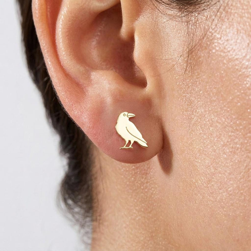 Pair of small gold raven bird stud earrings with sleek wings and a pointed beak (2 of 5)