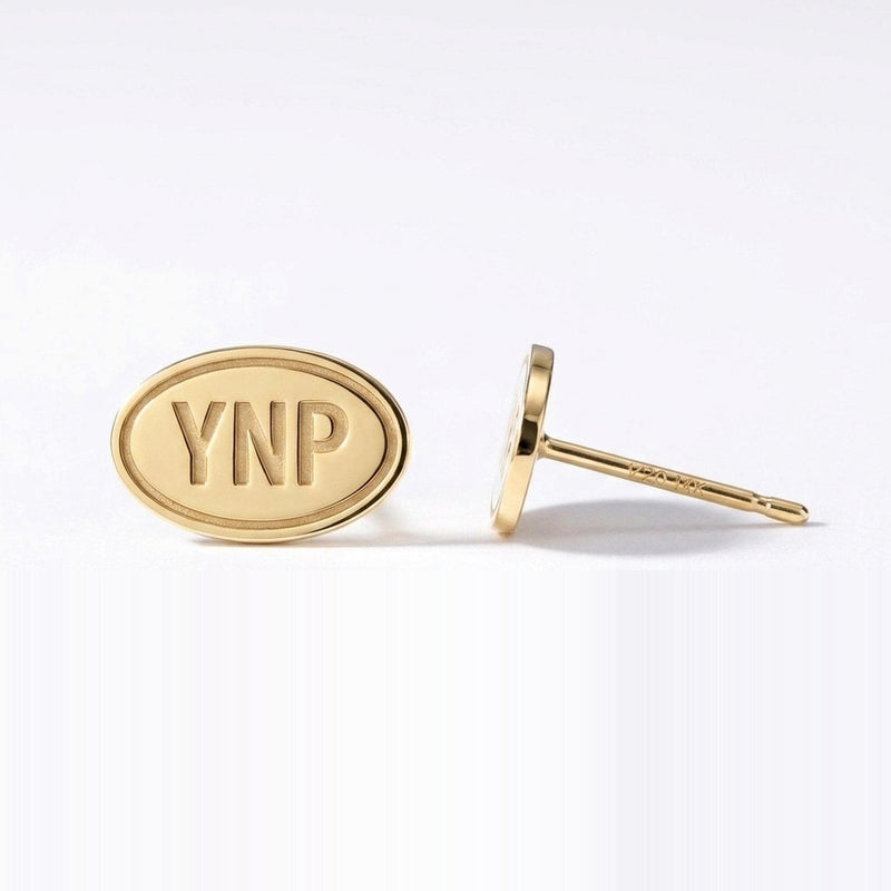 Pair of small gold oval stud earrings showing a Yellowstone landscape scene