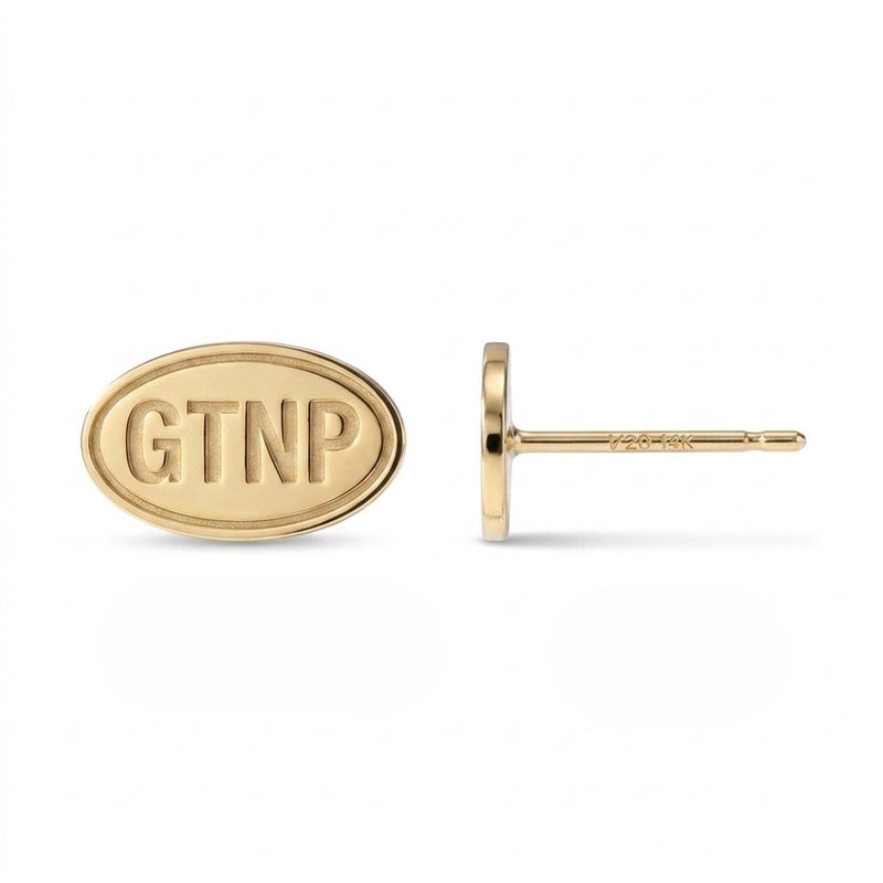 Pair of small gold oval stud earrings engraved with Grand Teton mountain peaks