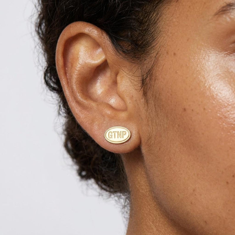 Pair of small gold oval stud earrings engraved with Grand Teton mountain peaks (2 of 5)