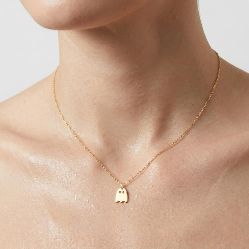 Small gold ghost pendant with a wavy hem hanging from a fine cable chain (2 of 9)
