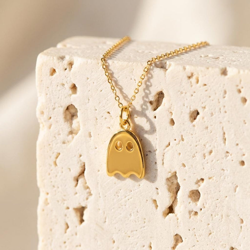 Small gold ghost pendant with a wavy hem hanging from a fine cable chain (4 of 9)