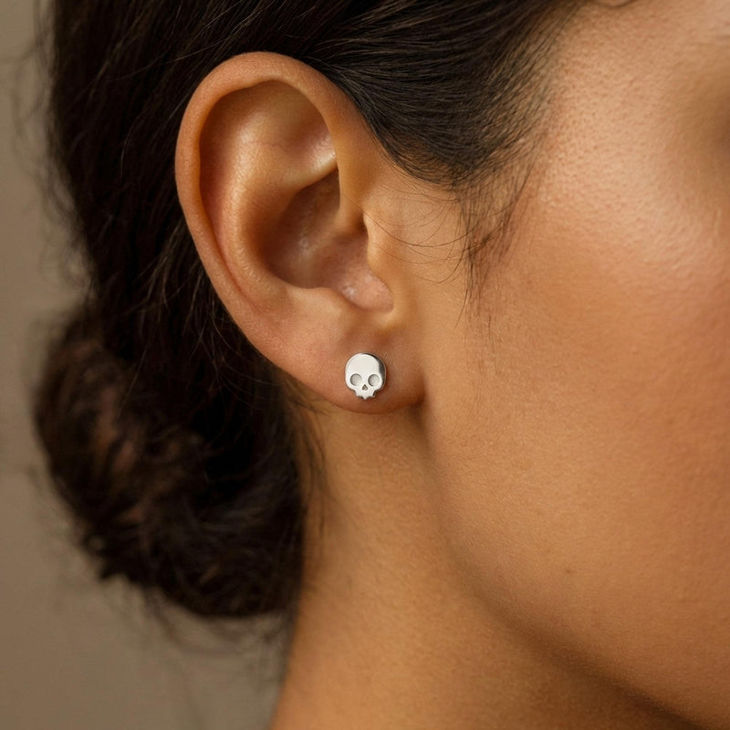 Pair of tiny gold skull stud earrings with round eye sockets (5 of 12)