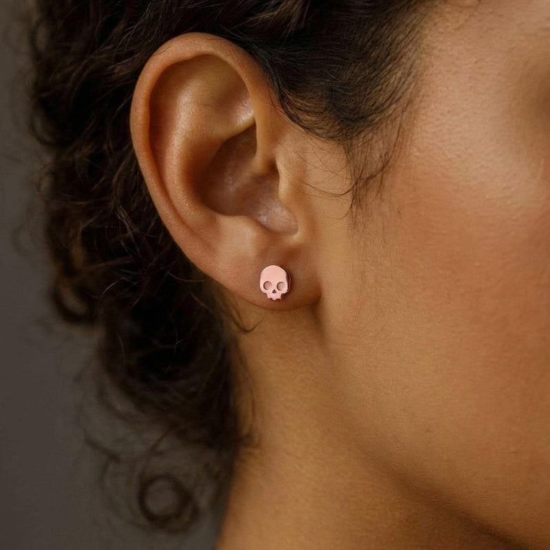 Pair of tiny gold skull stud earrings with round eye sockets (6 of 12)
