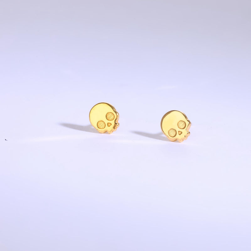 Pair of tiny gold skull stud earrings with round eye sockets (7 of 12)