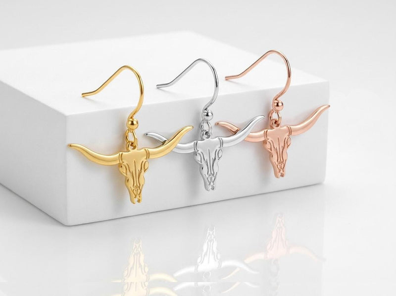 Pair of gold longhorn steer head stud earrings with wide curved horns