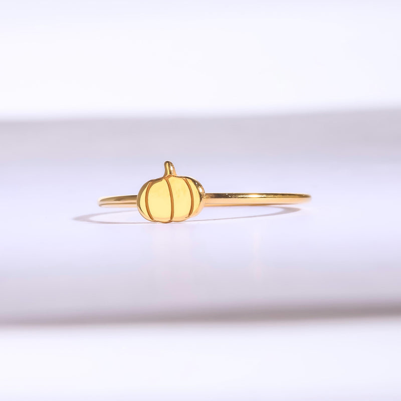 Thin gold ring topped with a small ribbed pumpkin charm with a curled stem (9 of 13)