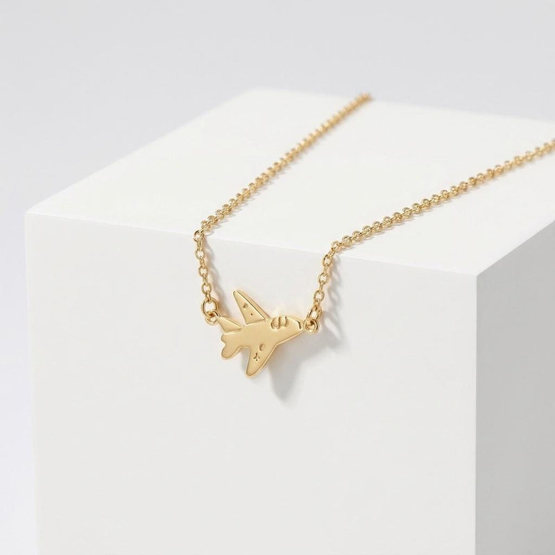 Small gold fighter jet pendant with swept wings on a fine cable necklace chain (2 of 7)