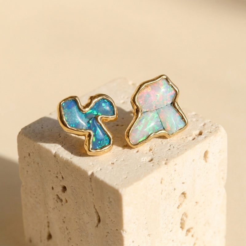 Mismatched Raw Opal Cluster Earrings on a travertine block