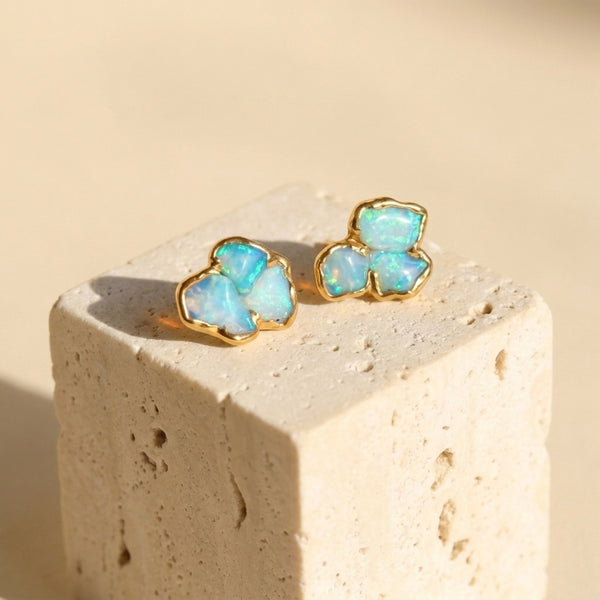 Raw Australian Opal Cluster Stud Earrings on a travertine block