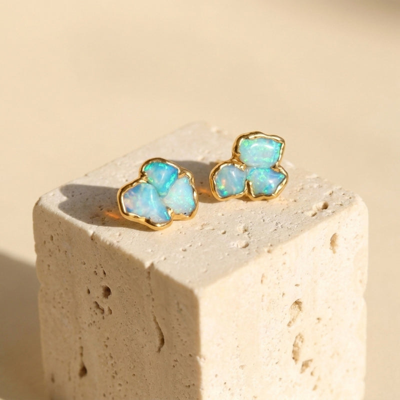 Raw Australian Opal Cluster Stud Earrings on a travertine block
