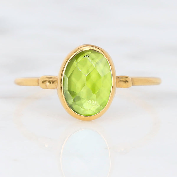 Raw Peridot Ring on a white background