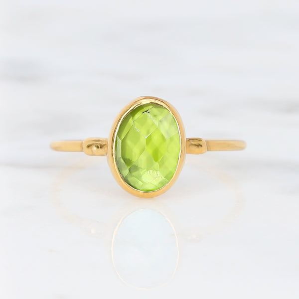 Raw Peridot Ring on a white background