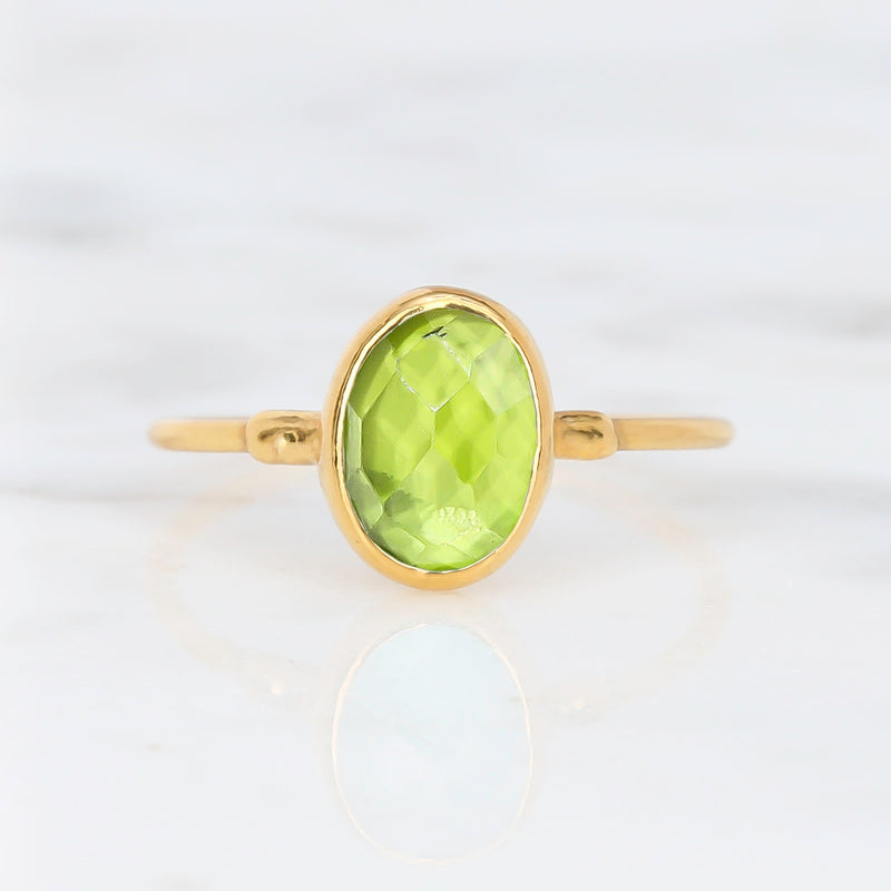 Raw Peridot Ring on a white background