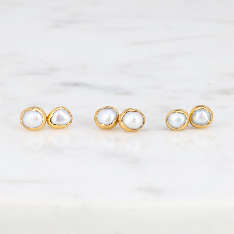 Mini Pearl Stud Earrings on a white background